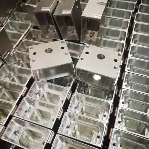 Precision CNC machined metal enclosures with drilled holes and smooth finishes.