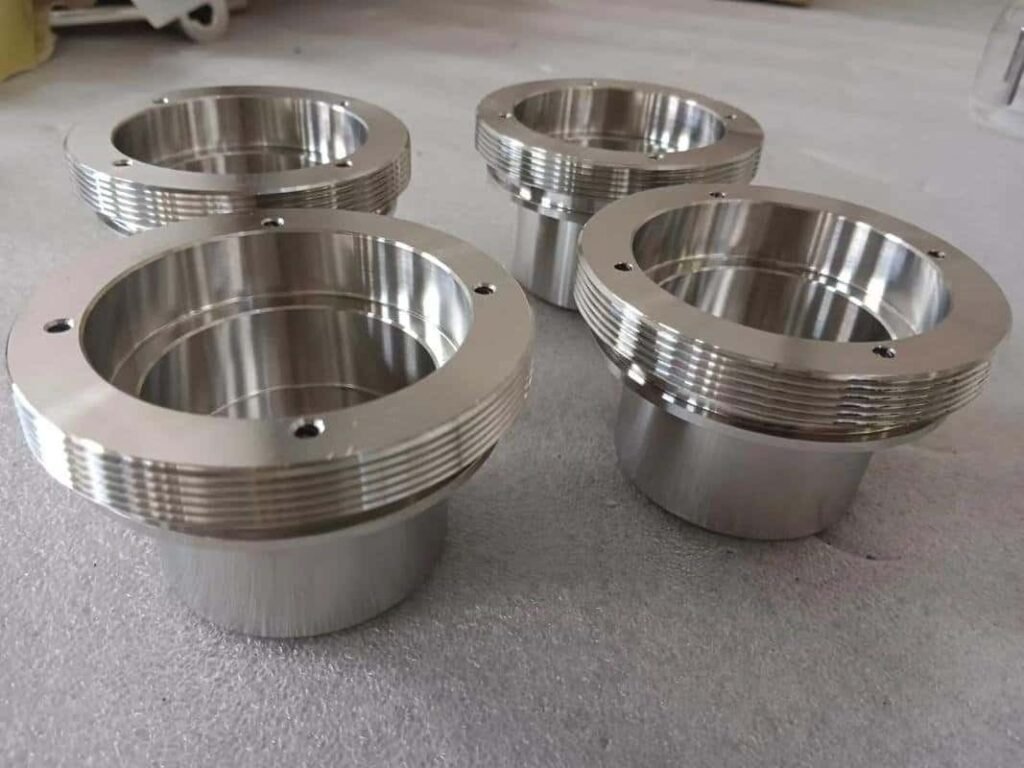 Precision-machined stainless steel CNC parts with threaded edges for industrial use.