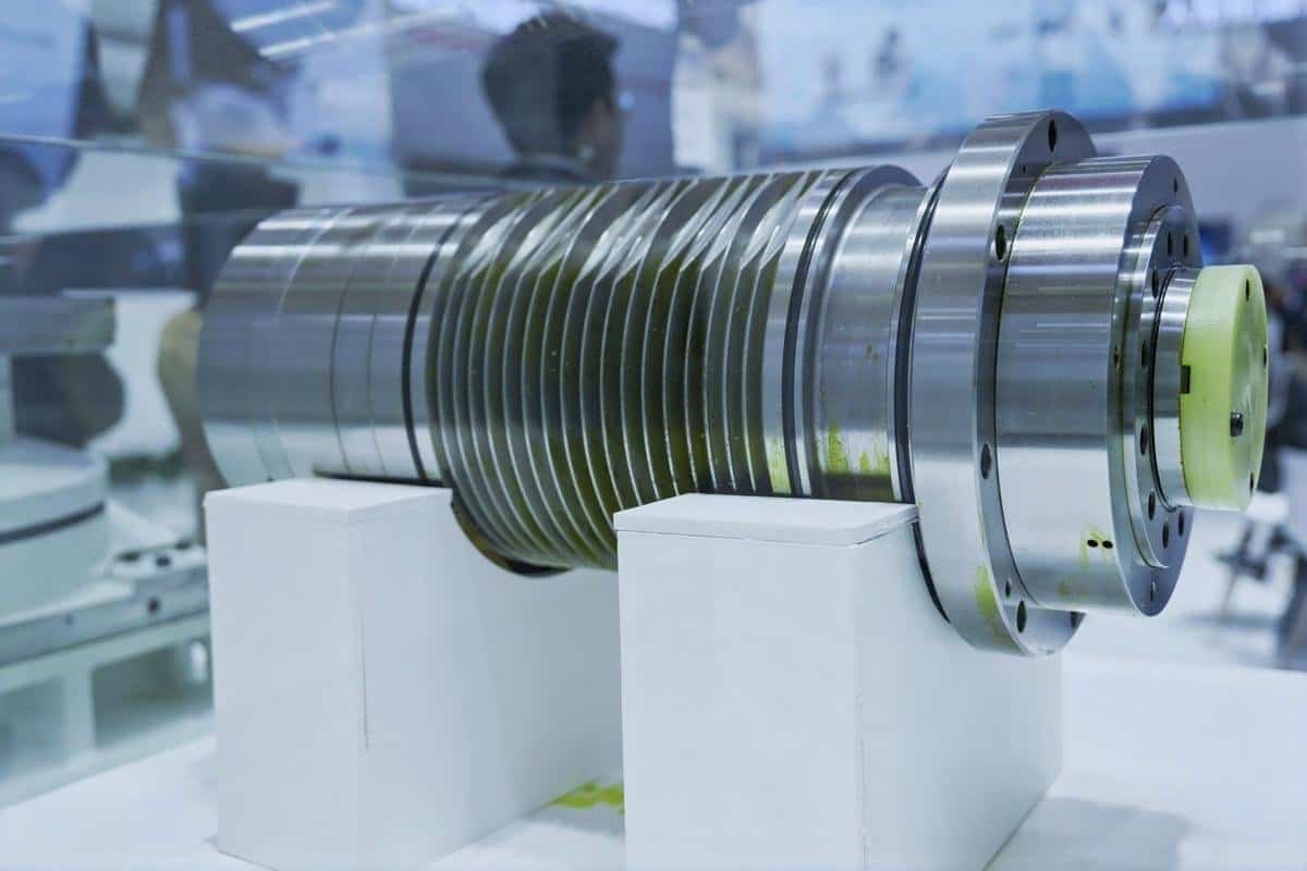 High-precision CNC machined metal component on display at a manufacturing exhibition.