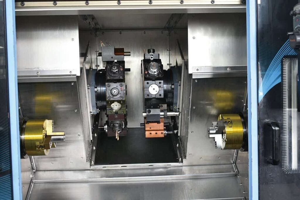 Multi-axis mill-turn center with dual spindles and a B-axis powered turret