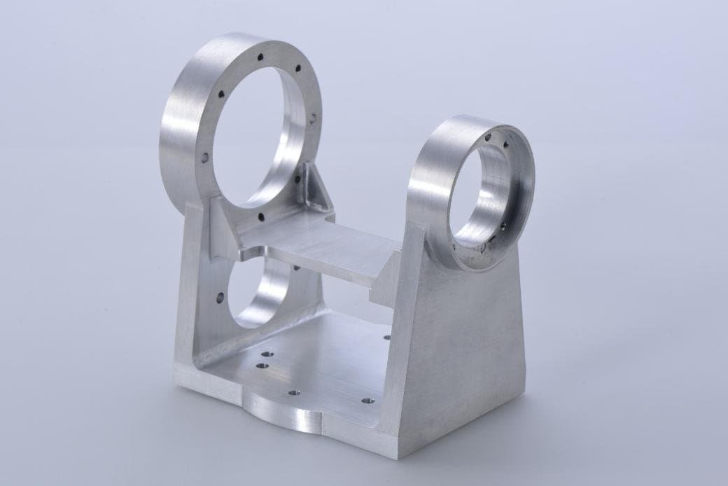 Machined support bracket with paired circular locating features