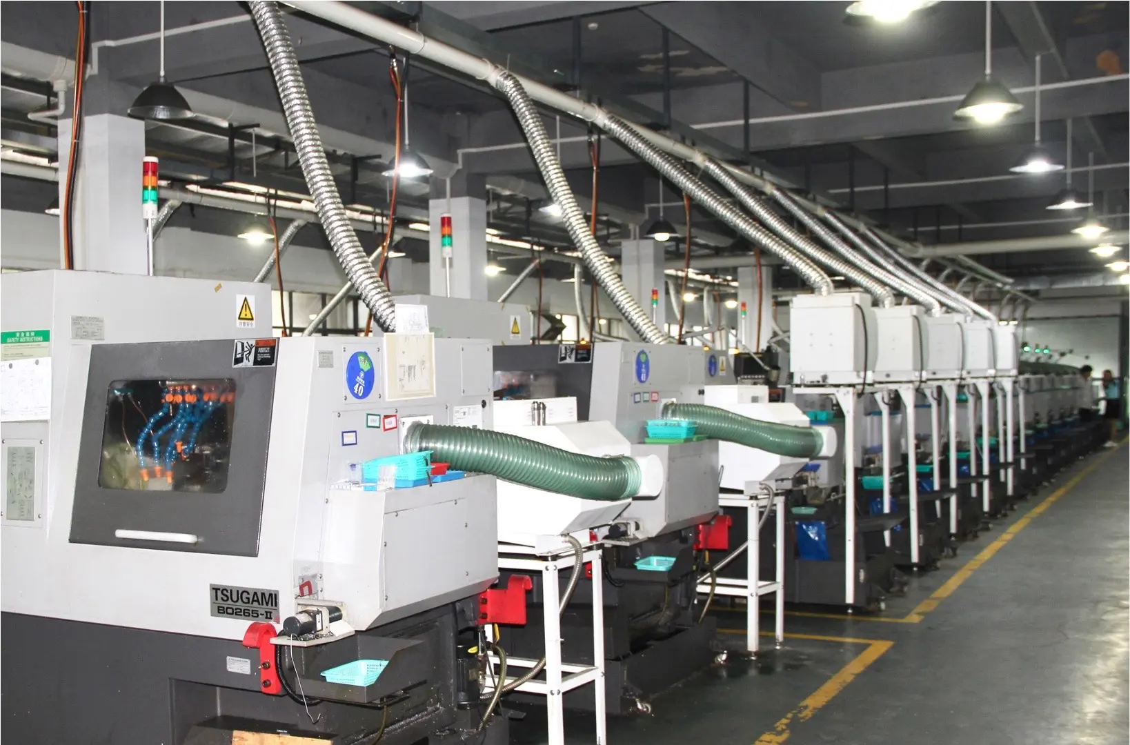 Row of Swiss-type CNC machines for small-diameter parts production