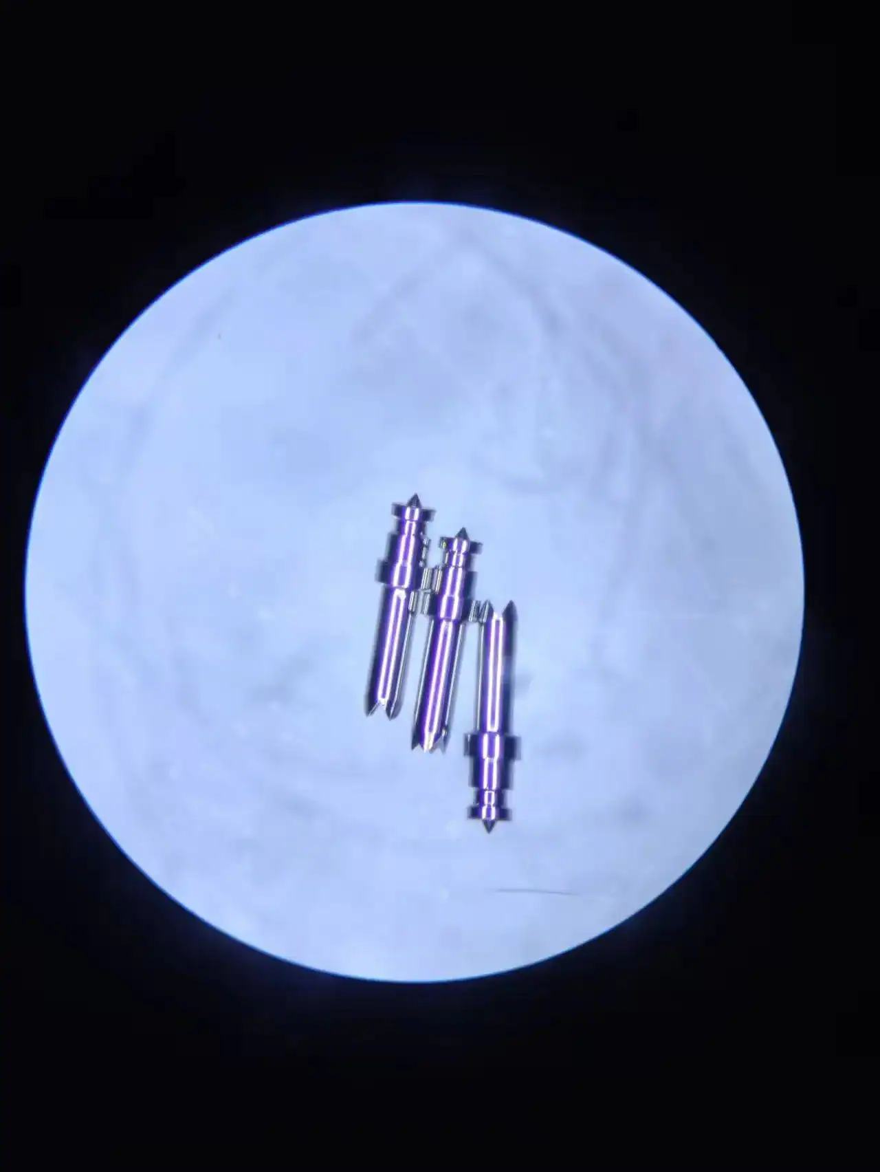 Miniature machined parts under a microscope