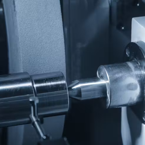 A cylindrical workpiece supported between centers
