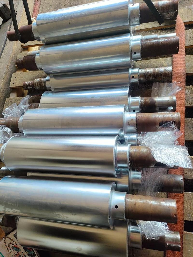Batch of metal shaft components arranged on a workshop rack