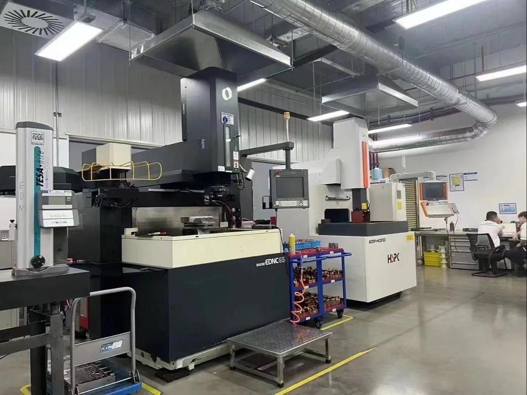 Row of sinker EDM machines in a precision machining workshop