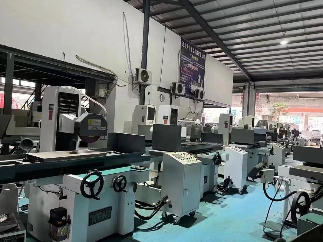 Row of surface grinding machines with flat work tables