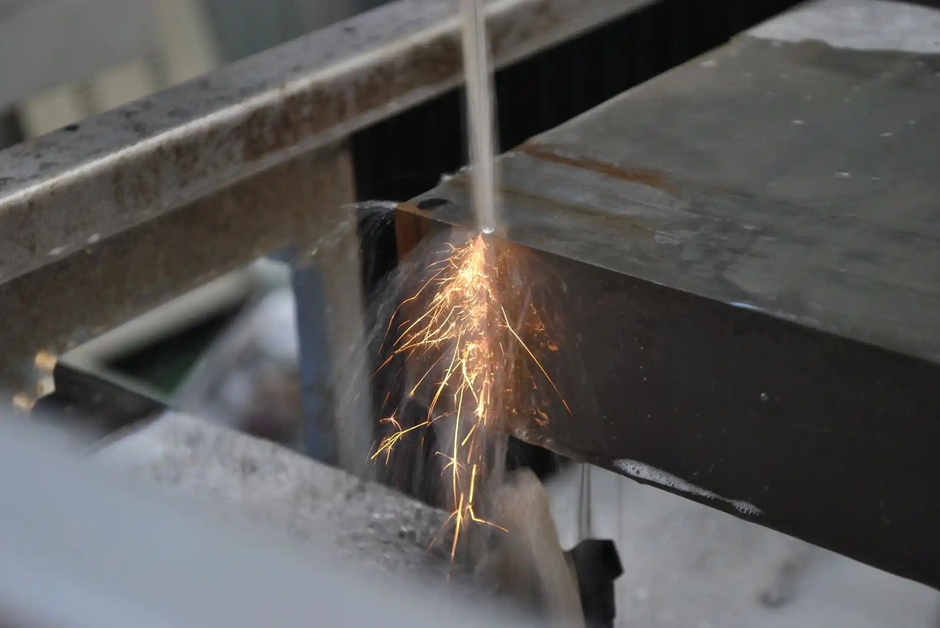 Wire EDM cutting the edge of a thick metal plate