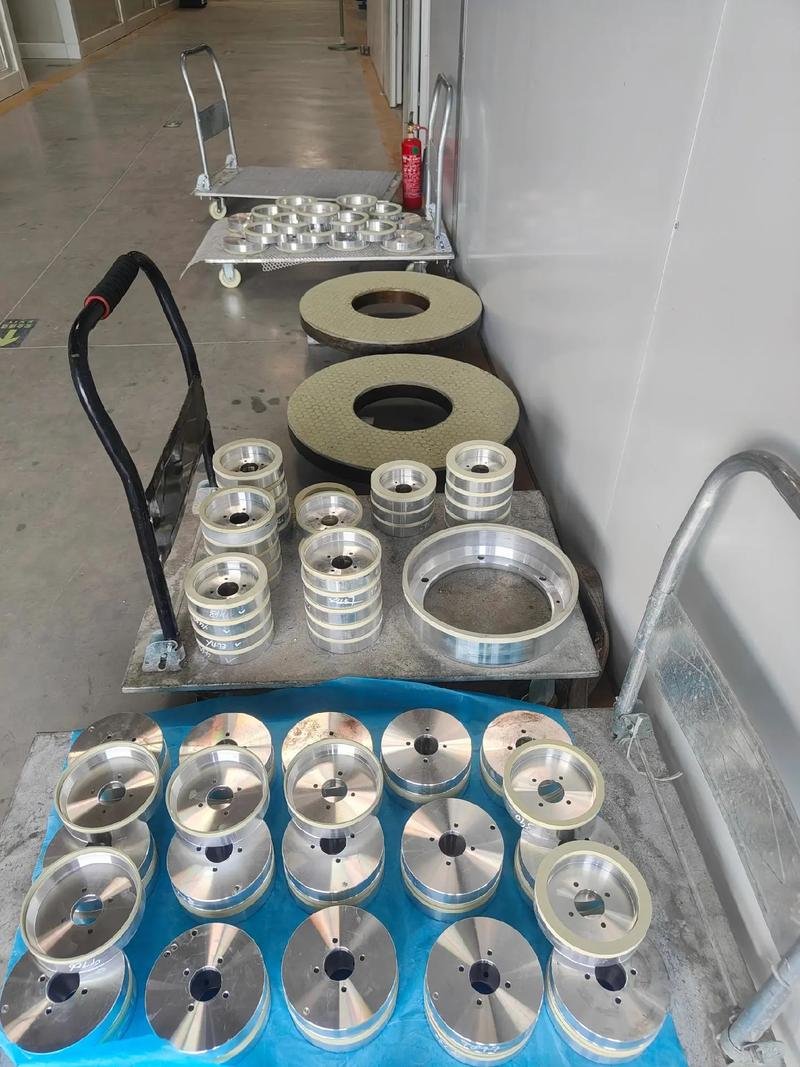 Metal rings and round components arranged on workshop trolleys